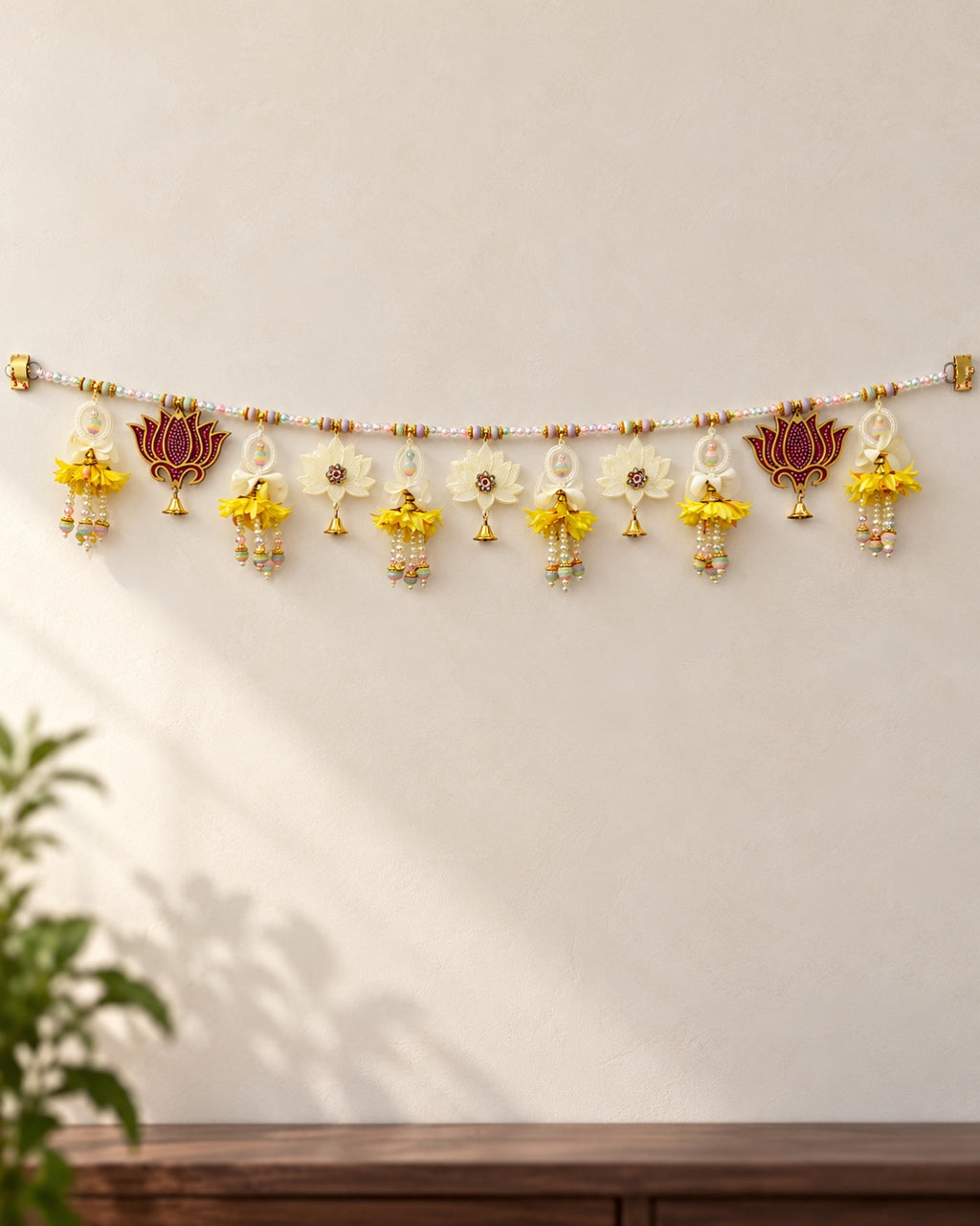 Kamal Yellow Blossom Toran - full product on a cream wall