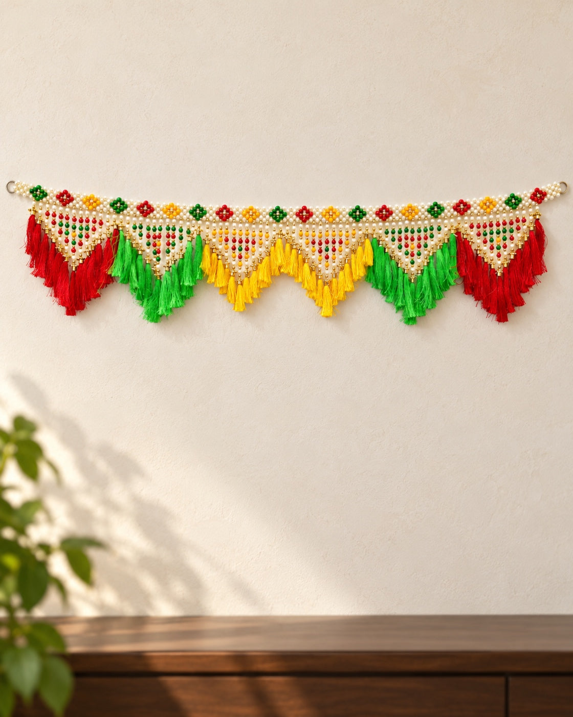 Rangoli Multicolour Tassel Toran - full product on a cream wall