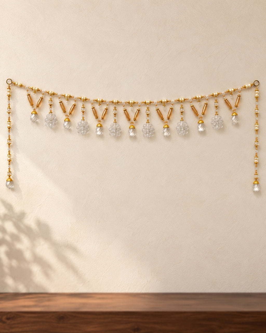 Amber Clear Drop Toran - full product on a cream wall