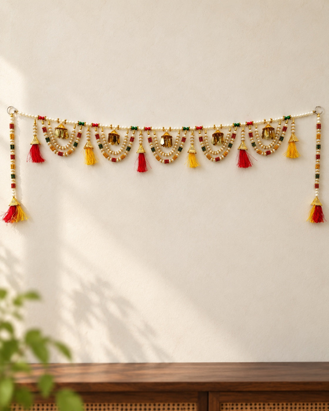 Rangoli Beaded Swag Toran - full product on a cream wall