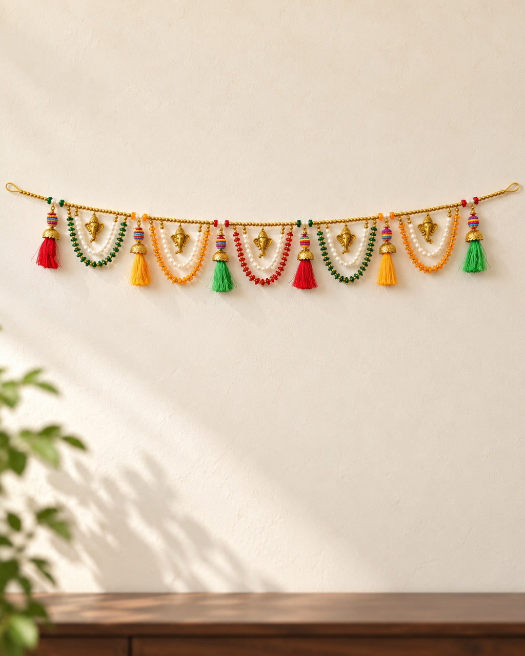 Ganesh Multicolour Tassel Toran - full product on a cream wall