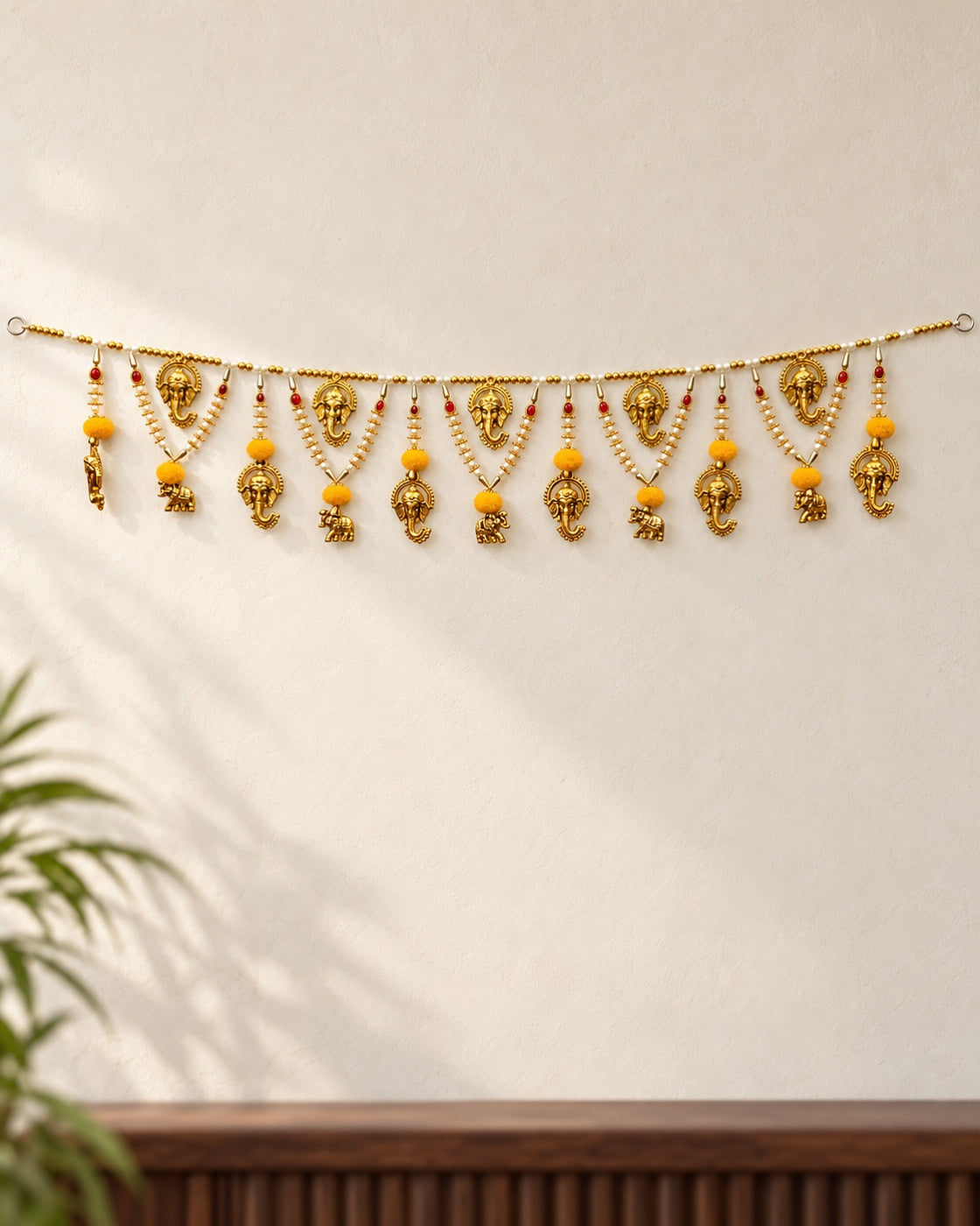 Ganesh Elephant Pom-Pom Toran - full product on a cream wall