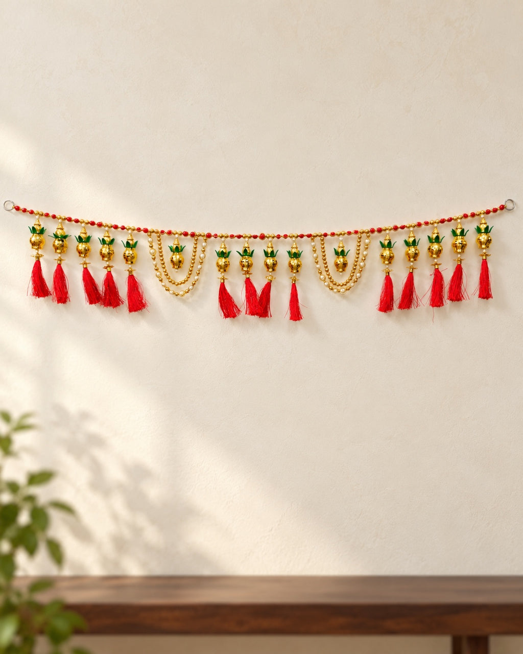 Kalash Red Tassel Toran - full product on a cream wall