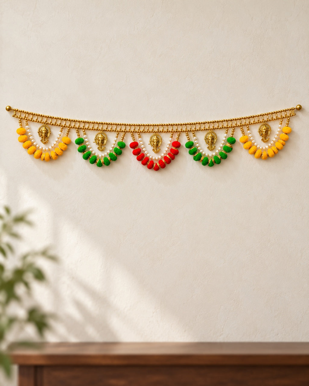 Ganesh Pom-Pom Swag Toran - full product on a cream wall