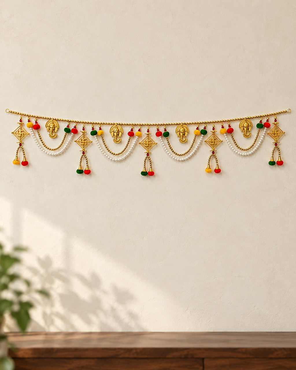 Ganesh Shubh Swastik Toran - full product on a cream wall