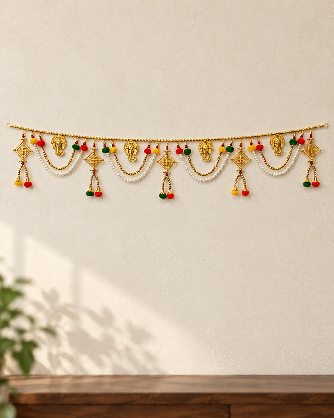 Ganesh Shubh Swastik Toran - full product on a cream wall
