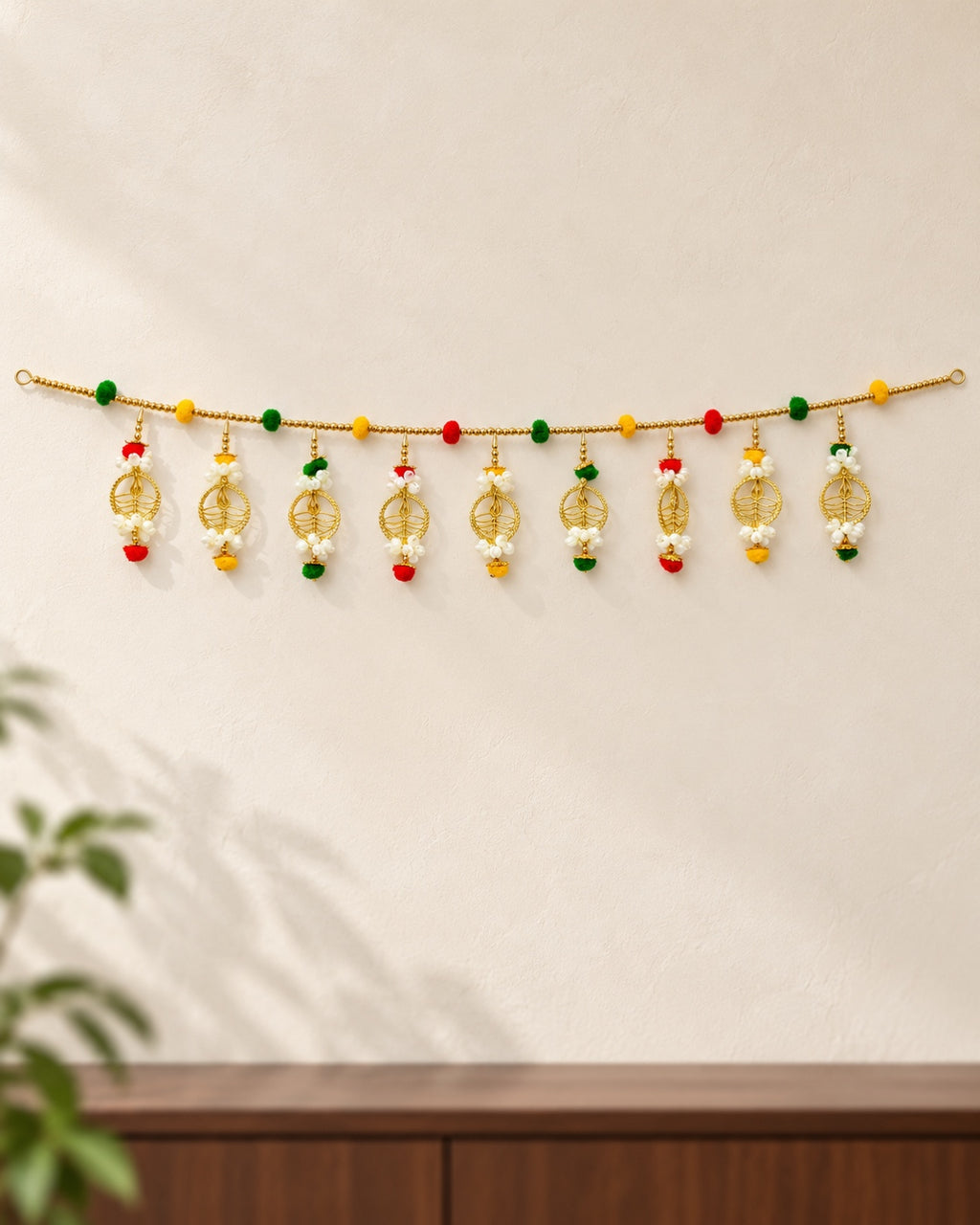 Golden Leaf Blossom Toran - full product on a cream wall